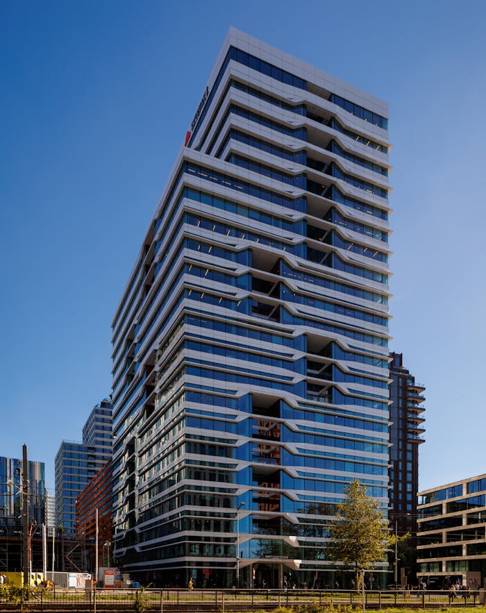 Contemporary high-rise building in Amsterdam's Zuidas business area on a clear day.